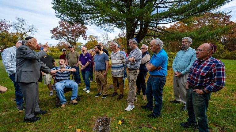 Rabbi Melvyn Lerer addressing visitors at a prayer service Sunday...