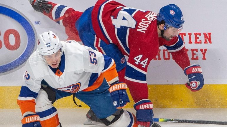 Montreal Canadiens centre Nate Thompson (44) is checked by Islanders...