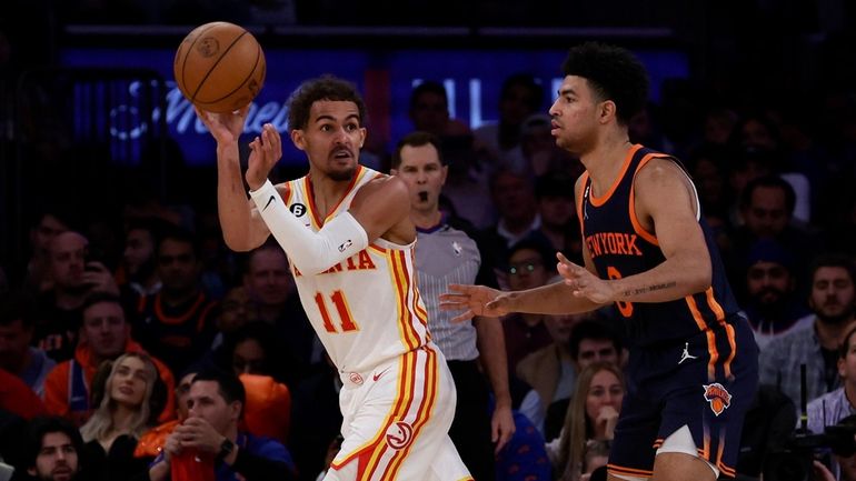 Trae Young #11 of the Atlanta Hawks controls the ball...