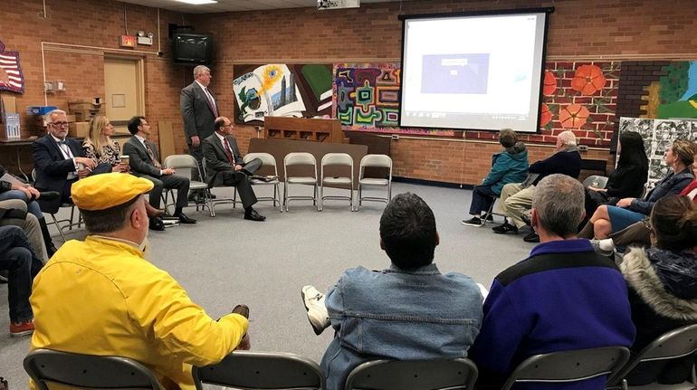 Port Jefferson residents and school district officials watch a video...