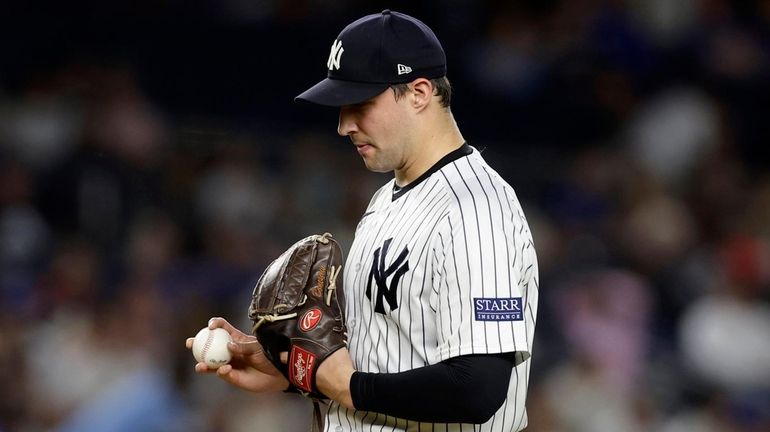 Tommy Kahnle of the Yankees reacts after walking in a run...