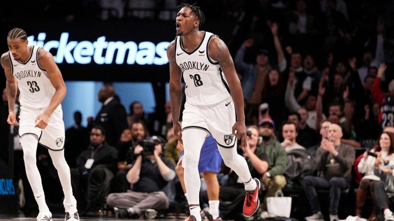 Dorian Finney-Smith of the Brooklyn Nets celebrates after making basket...