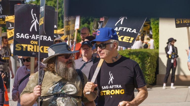 Actors Jack Black, left, and Bob Odenkirk join demonstrators outside...