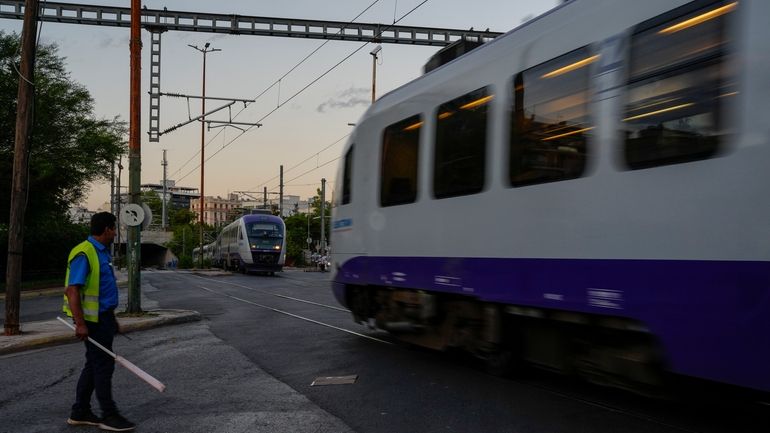 A member of the Greece railway staff looks on at...