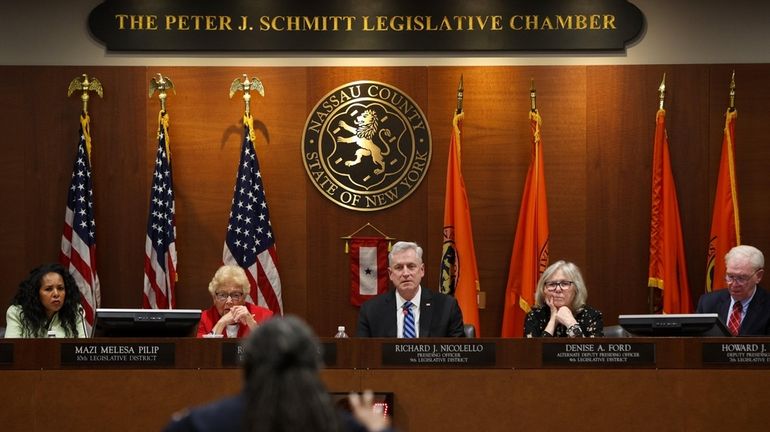 Presiding Officer Richard Nicolello, center, looks on as Kelly Johnson...