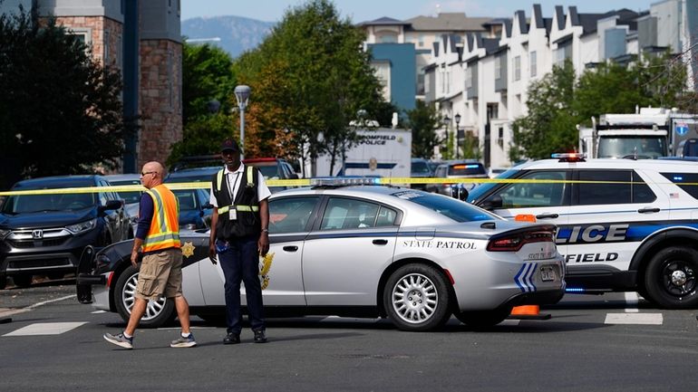 Law enforcement officials at the scene of a shooting in...