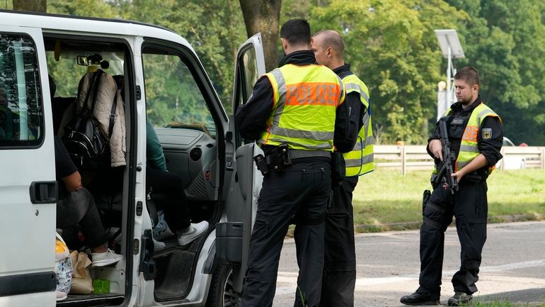 German police check the details of a van from Bulgaria...