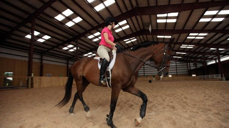 Megan Devine, 20, of Rockville Centre, enjoys a ride on...