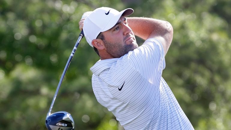 Scottie Scheffler tees off on the first hole during the...