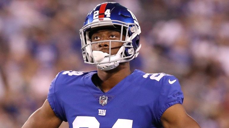 Giants cornerback Eli Apple waits for play to resume during...