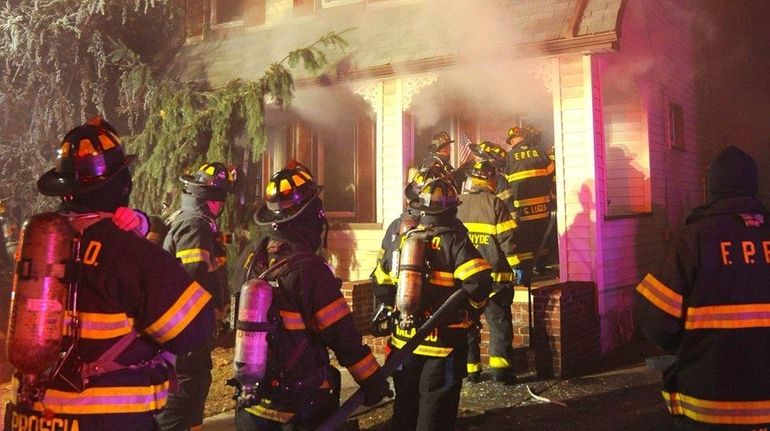 Firefighters at the scene of a house fire on Iris...