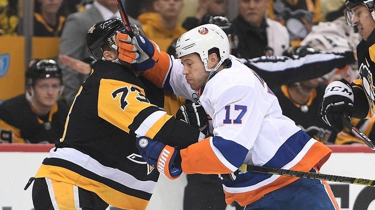 Matt Martin #17 of the Islanders battles with Jack Johnson #73...