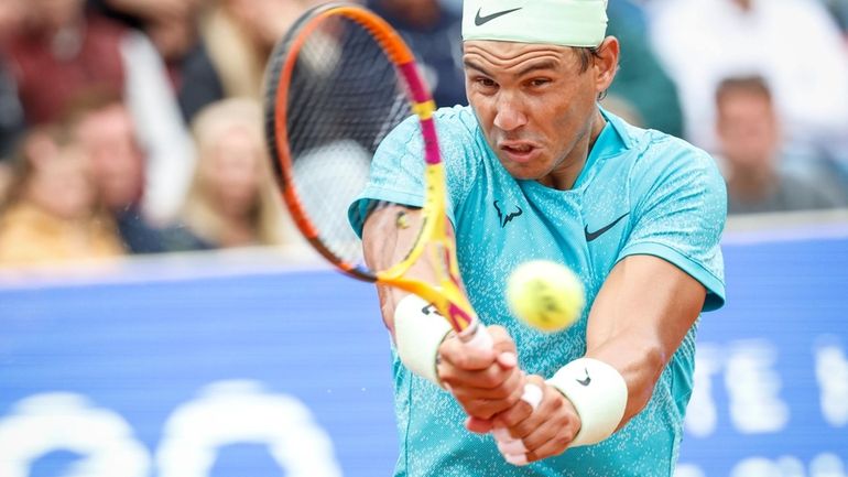 Rafael Nadal of Spain plays a backhand during his men's...