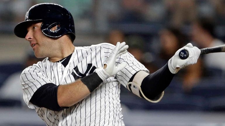 New York Yankees' Austin Romine follows through on an RBI...