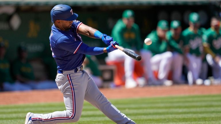 Texas Rangers' Ezequiel Duran hits a two-run home run against...