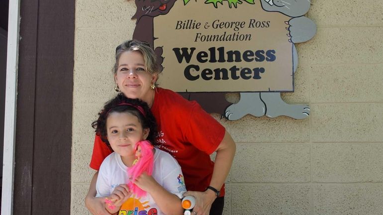 Katie Gallardo hugs her daughter Gina, a leukemia survivor, outside...