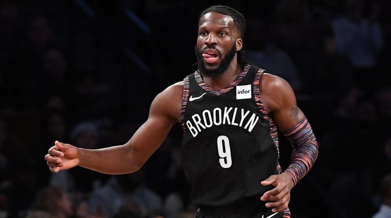 Nets forward DeMarre Carroll looks on after sinking a three-point...
