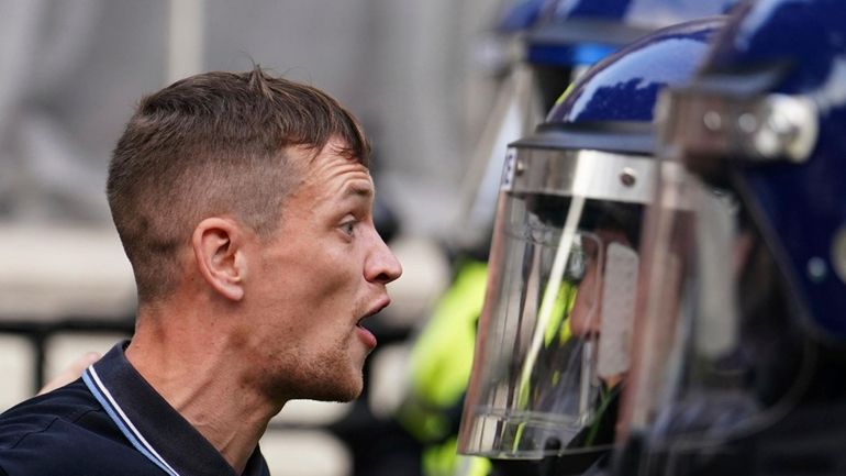 Protesters confront police during the "Enough is Enough" protest in...