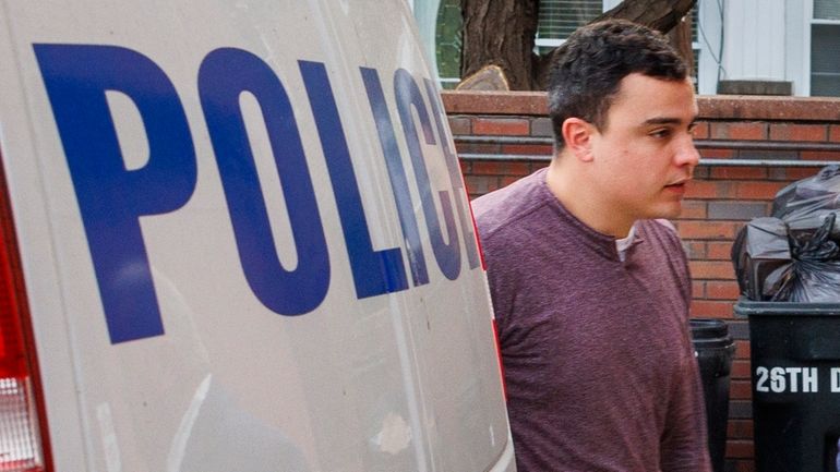 Philadelphia police officer Mark Dial enters the 1st Police District,...