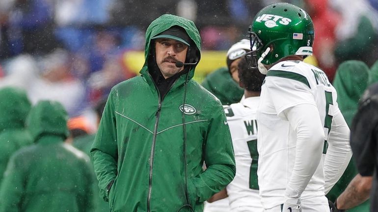 Jets quarterback Aaron Rodgers stands on the sidelines during the first...