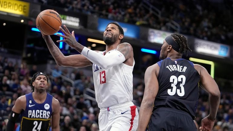 LA Clippers' Paul George (13) puts up a shot over...