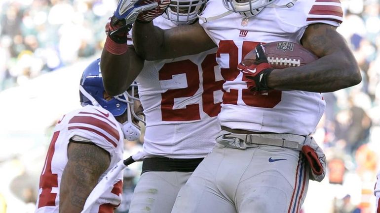 Giants defensive back Will Hill (no. 25) celebrates with teammate...