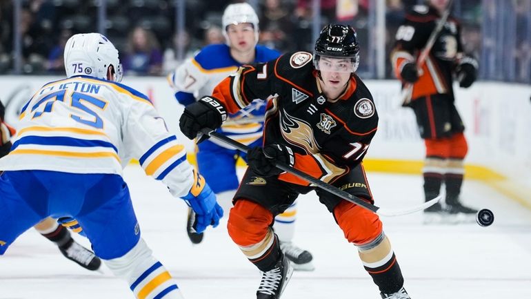 Anaheim Ducks right wing Frank Vatrano, right, clears the puck...