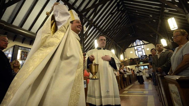 Bishop Robert Brennan blesses the Church and parishioners during services...