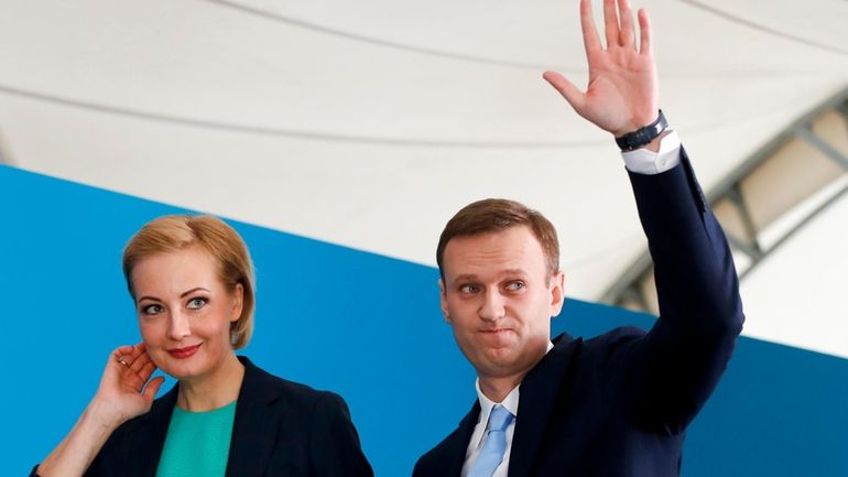 Russian opposition leader Alexei Navalny and his wife Yulia attend...