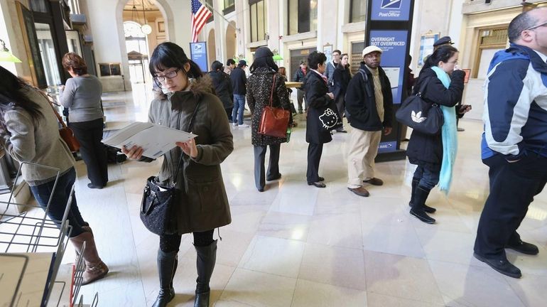 A Tax Day crowd at the Farley Post Office in...