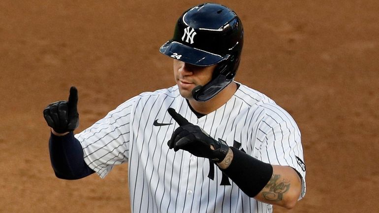 Gary Sanchez of the Yankees reacts at first base after his...