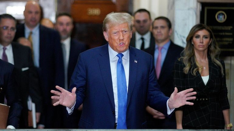 Former President Donald Trump speaks outside the courtroom after testifying...