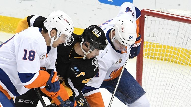 Penguins captain Sidney Crosby is stopped by Islanders goalie Ilya Sorokin while...