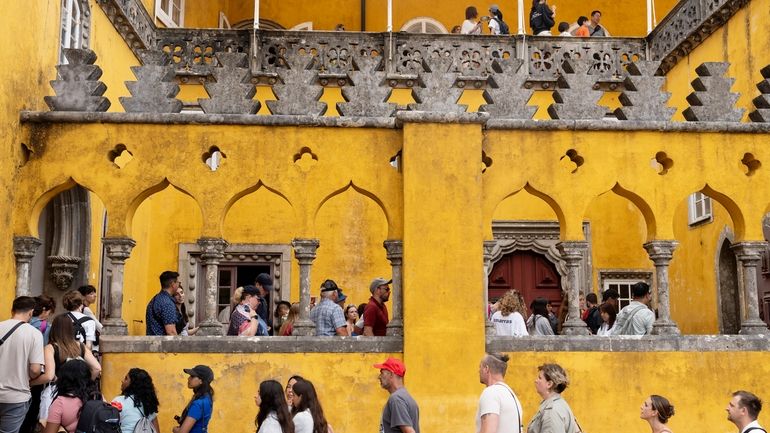 Tourists queue to visit the interior of the 19th century...