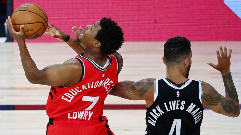 Toronto Raptors guard Kyle Lowry (7) shoots while getting fouled...