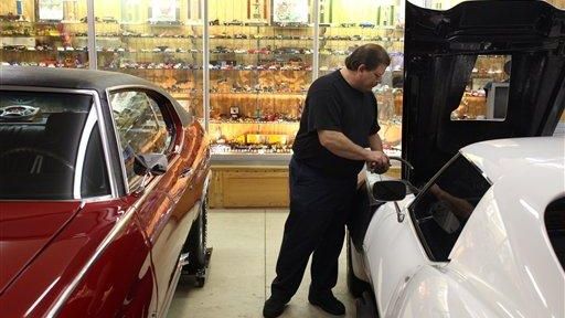 Perry Weaver works on a customer's 1968 Corvette at his...