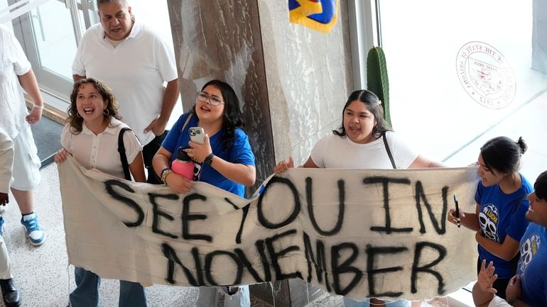 Opponents to an immigration proposal gather inside the Arizona State...