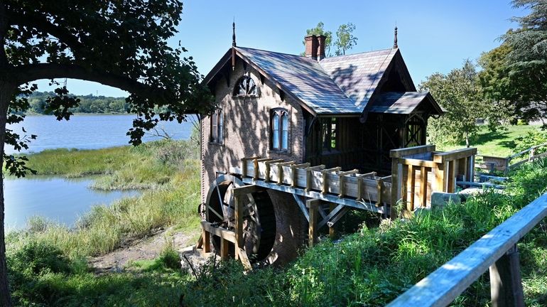 Renovations to a waterwheel at a Roslyn Harbor mill that...