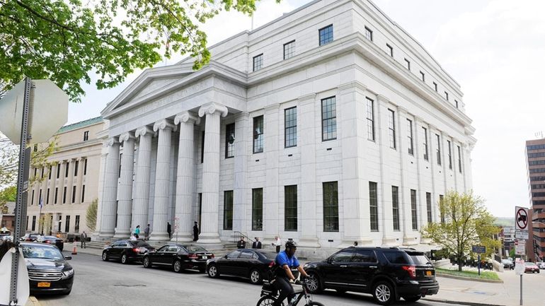 A Police cyclist rides past the New York Court of...