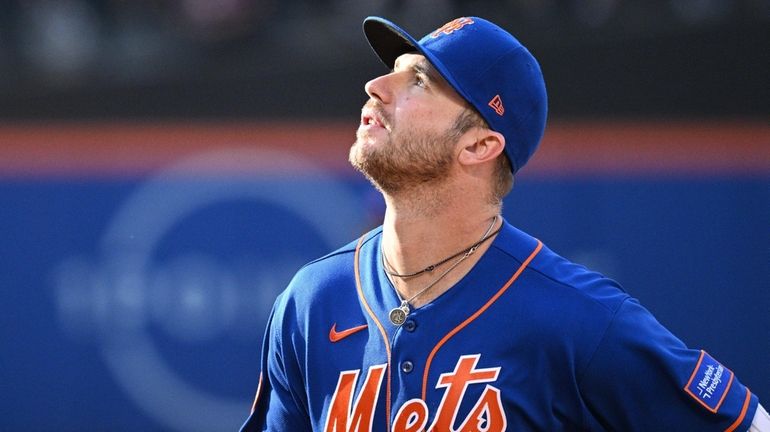 Mets first baseman Pete Alonso looks on from the infield...