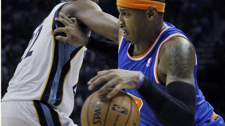 Carmelo Anthony, right, pushes off the Memphis Grizzlies' Rudy Gay...