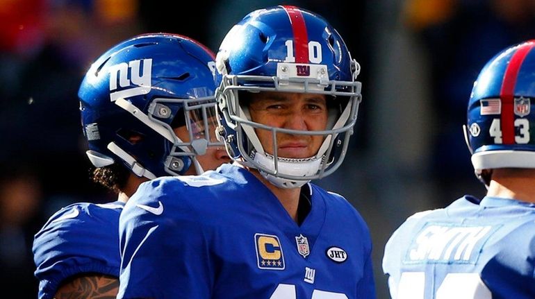 Eli Manning #10 of the New York Giants looks on...