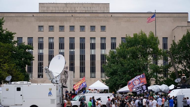 Media and protesters outside E. Barrett Prettyman US Federal Courthouse,...