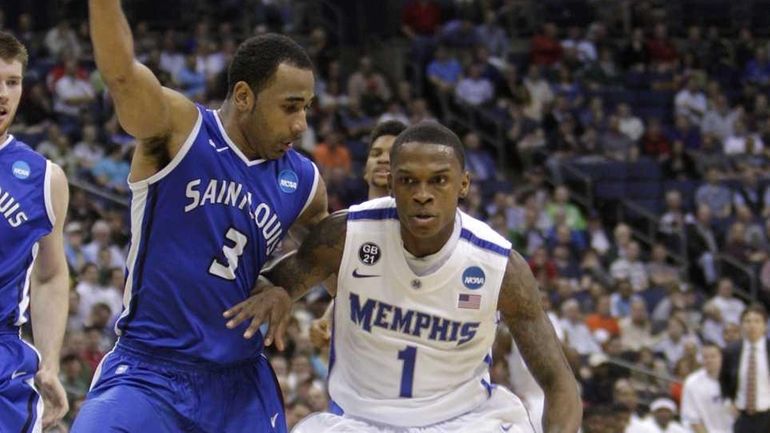 Memphis' Joe Jackson drives to the basket as Saint Louis'...