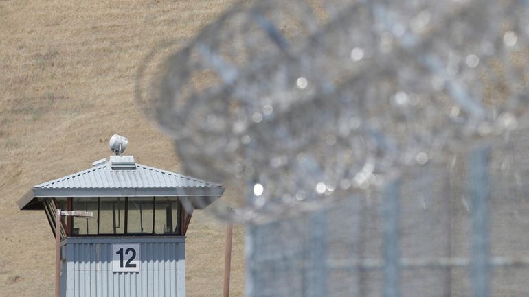 A guard tower and razor wire are seen at California...