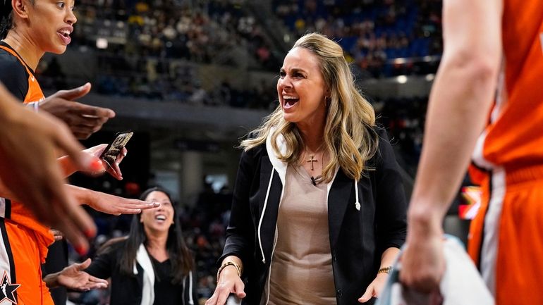 Team Wilson head coach Becky Hammon talks to players during...