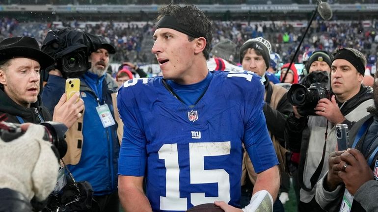 Giants quarterback Tommy DeVito (walks off the field after defeating...