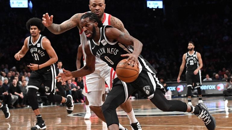Brooklyn Nets forward DeMarre Carroll drives to the basket defended...