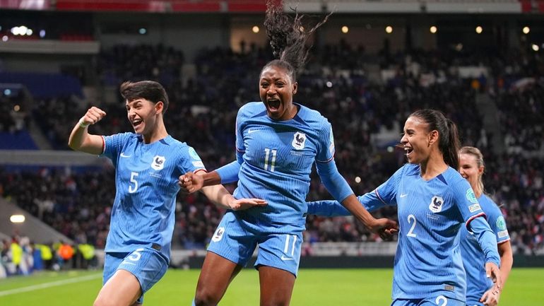 France's Kadidiatou Diani, centre, celebrates with teammates after scoring her...