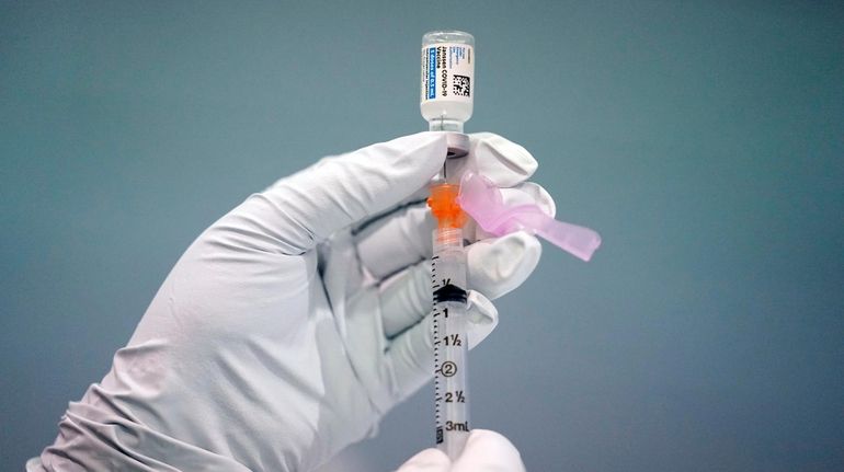 A member of the Philadelphia Fire Department prepares a dose...